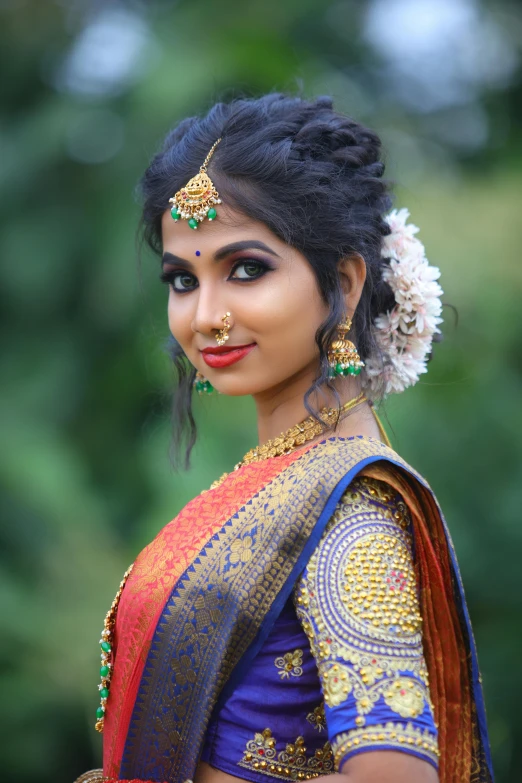 a woman wearing a traditional indian garb is pographed