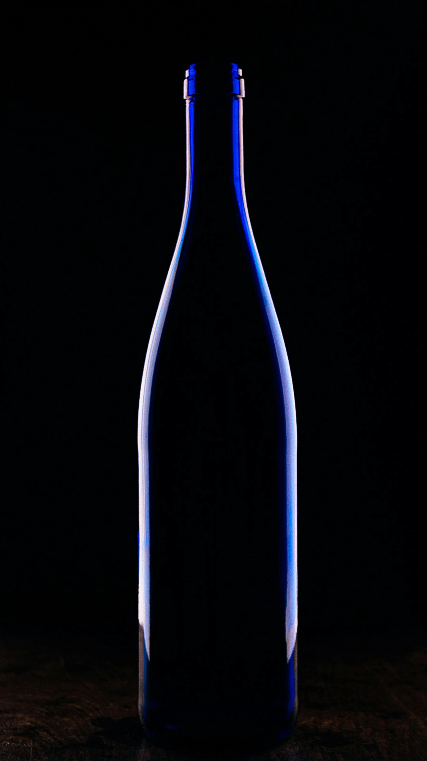 a wine bottle that is on a dark background