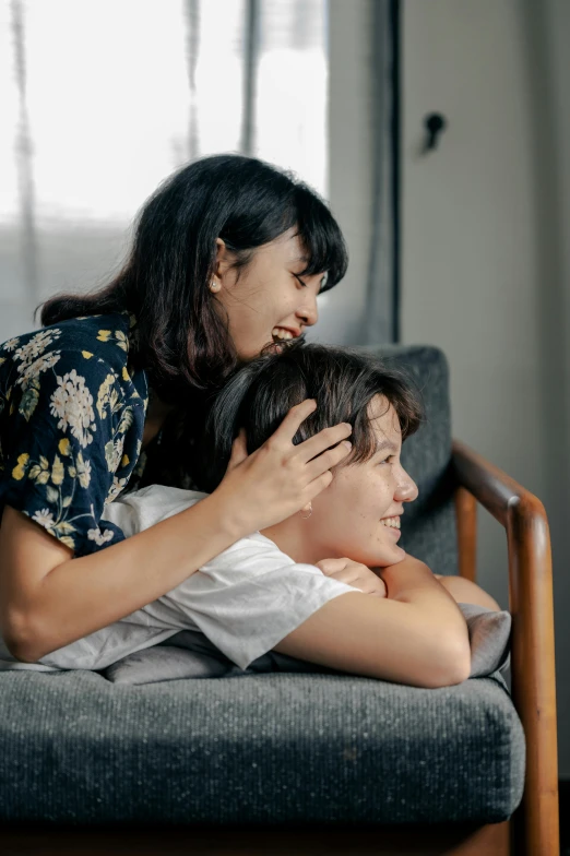 a woman is giving her new hair cut by another