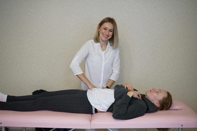 woman in a white blouse receiving a facial massage