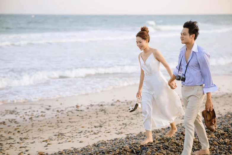 a man and a woman walking on a beach