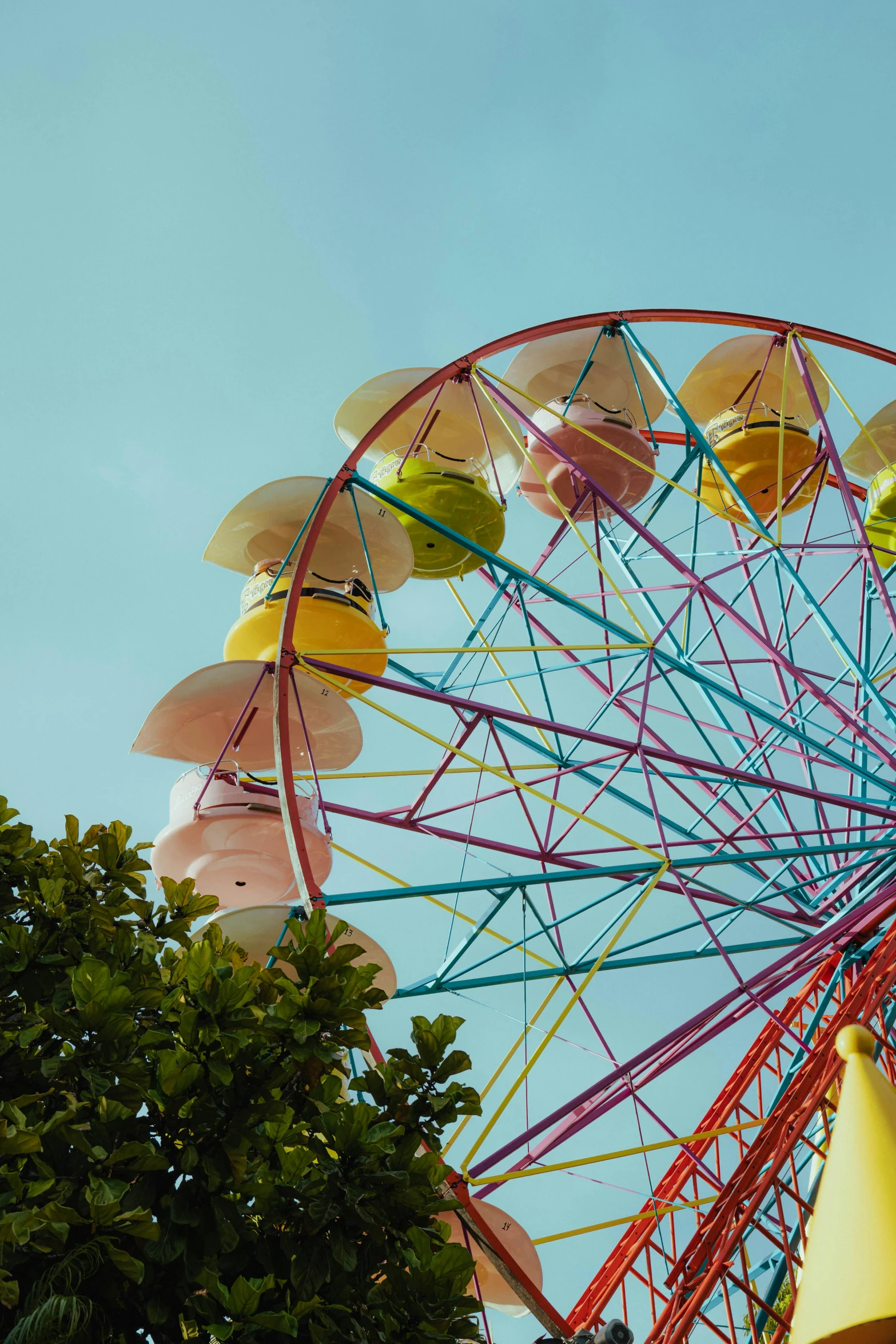 an amut ride with umbrellas sitting above the trees