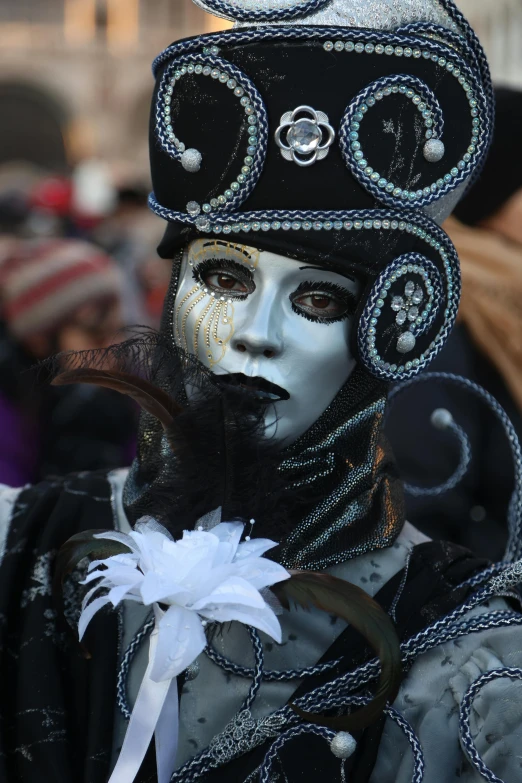 a man is dressed in a black hat and body paint