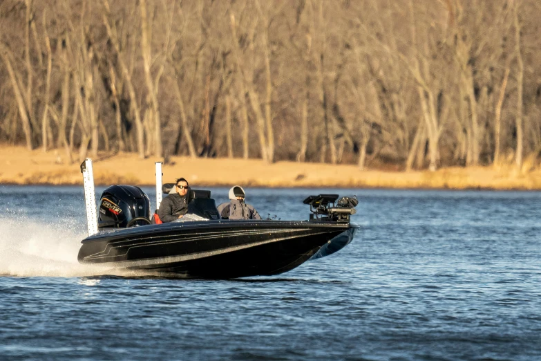 two people are riding in a small black boat