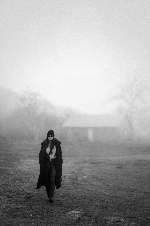 a woman standing on top of a dirt field