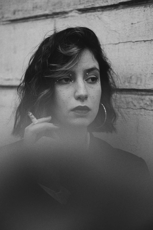 a young woman with curly hair and bangs looks down