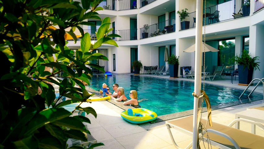 a group of people are enjoying their time in the pool