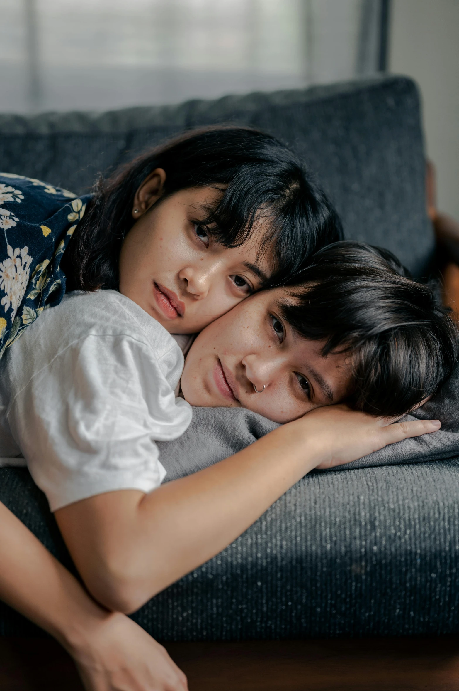 a couple of women laying next to each other