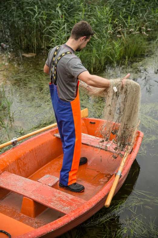 a man is cleaning up a fish in a small boat