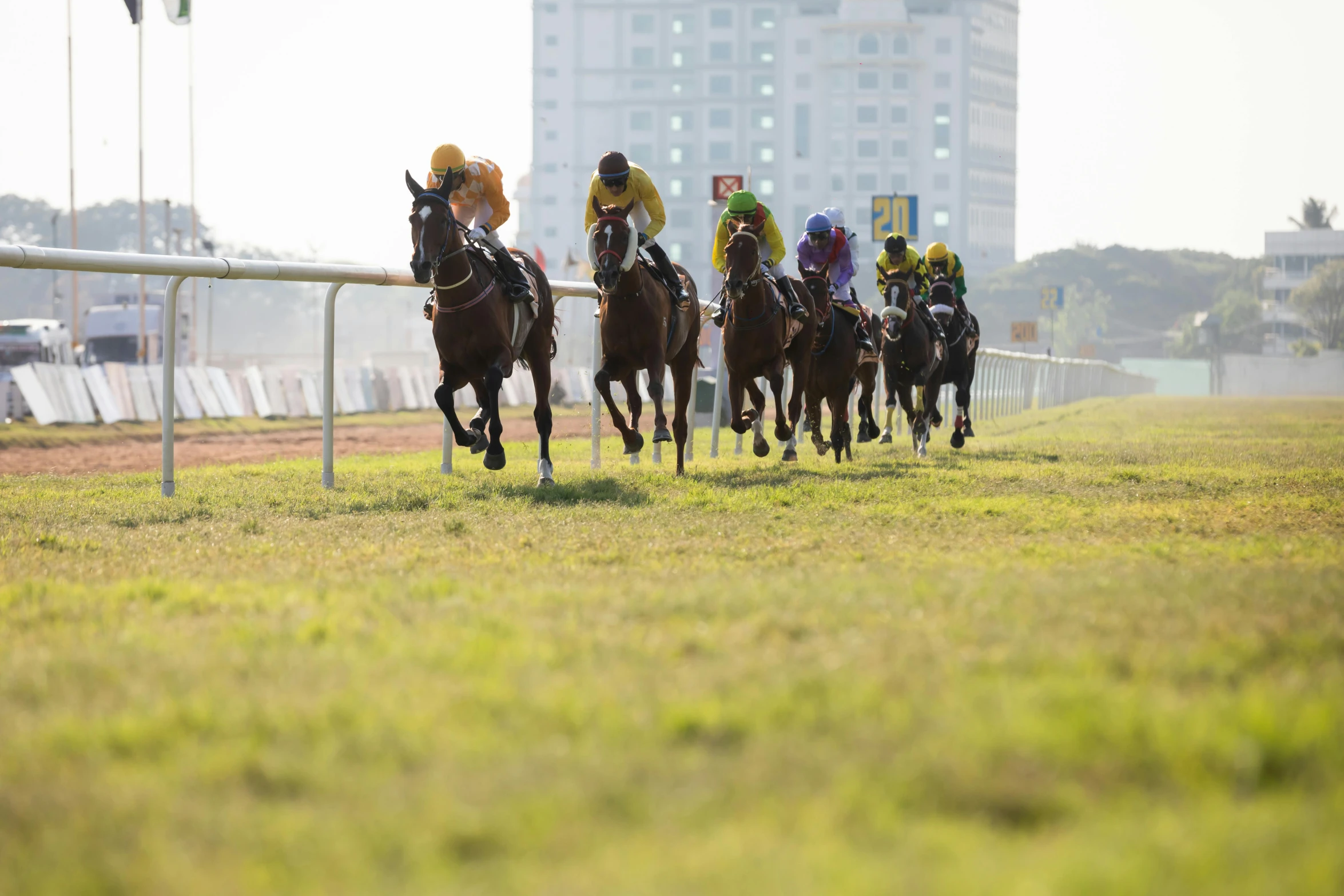 a horse racing team is on their way around the track