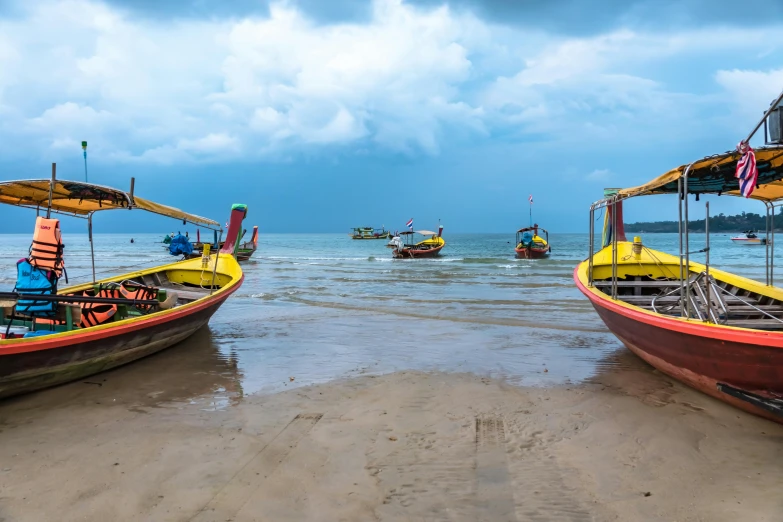 several boats on shore near one another in water