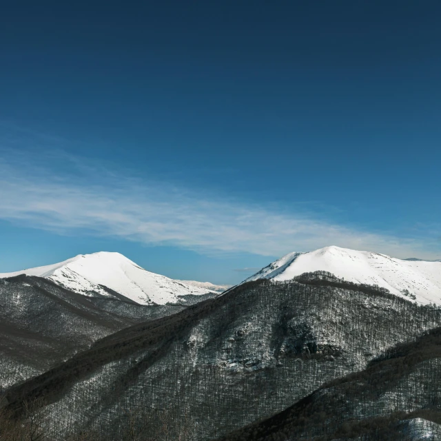 a group of snow covered mountains in winter