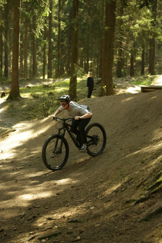 a man is riding a bike in the forest