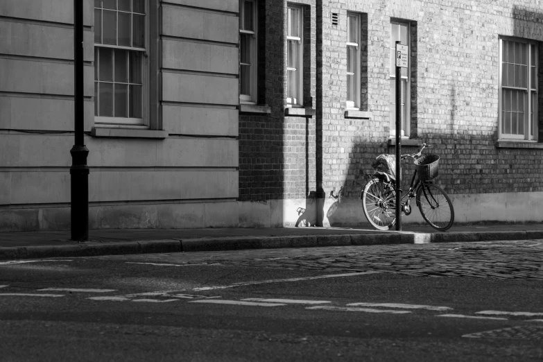 a bike parked up against the side of a building