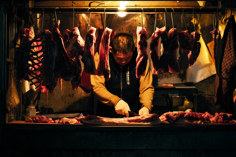a man is preparing his meat in the kitchen