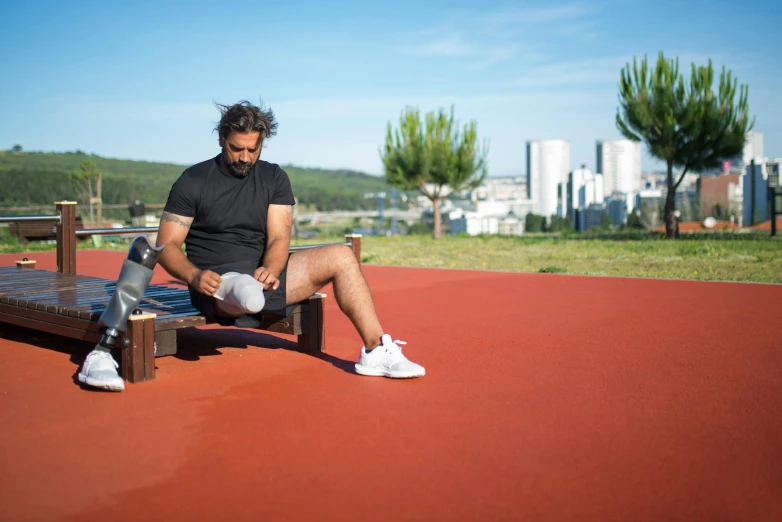 a person sitting on a bench with their feet up