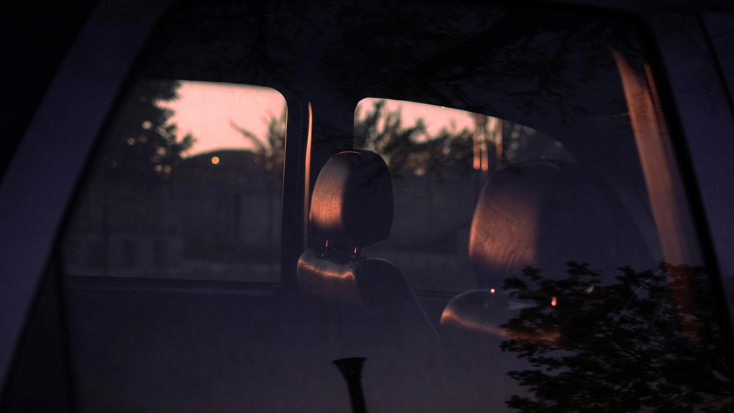 a rear view mirror reflecting a person driving