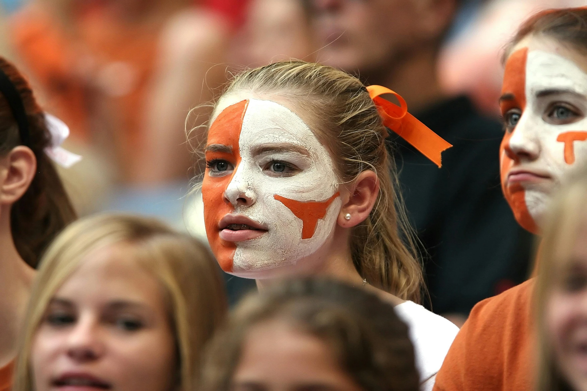 two s with their faces painted in orange and white