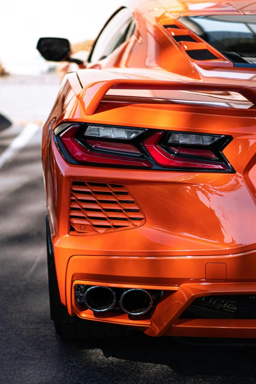 an orange sports car parked on the road