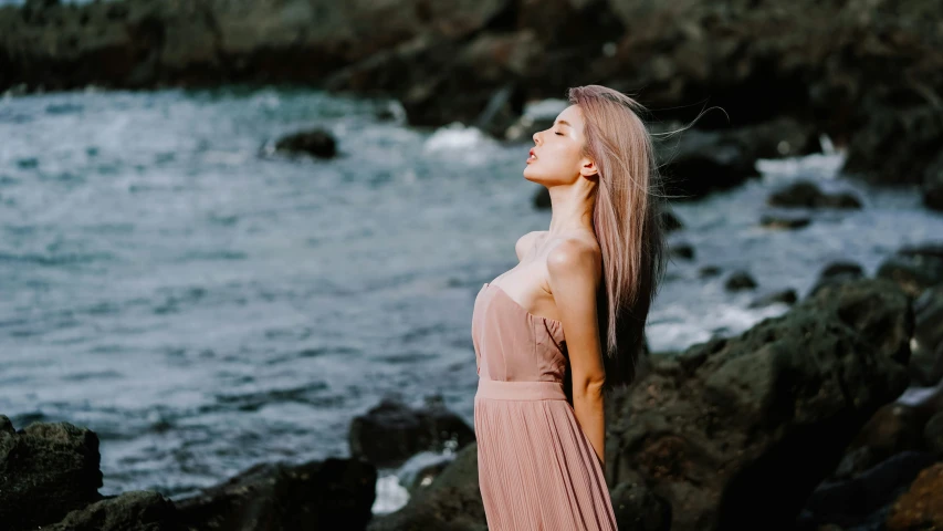 a girl looking out over the water while staring ahead