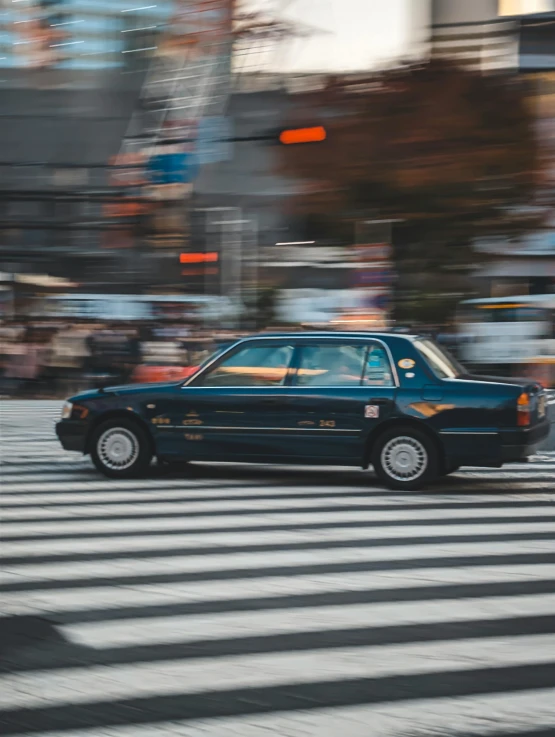 a taxi that is sitting in the middle of a cross walk