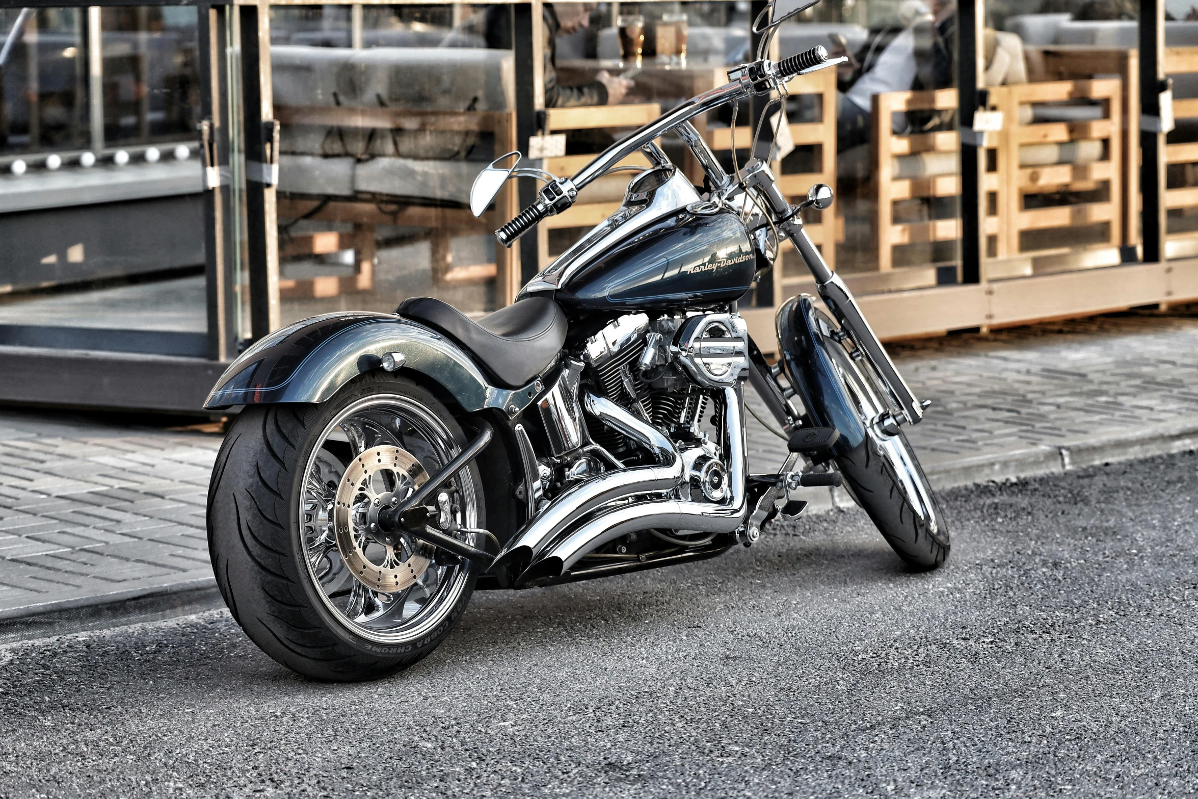 a large black motorcycle is parked in front of a store