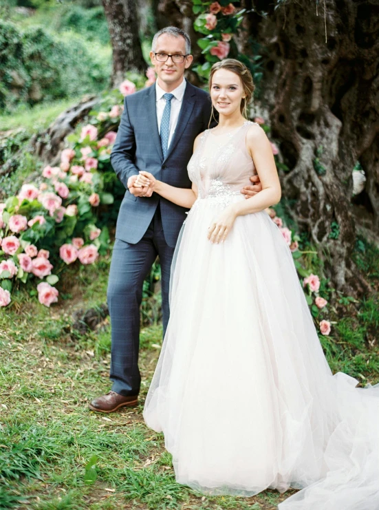 bride and groom in formal attire holding hands