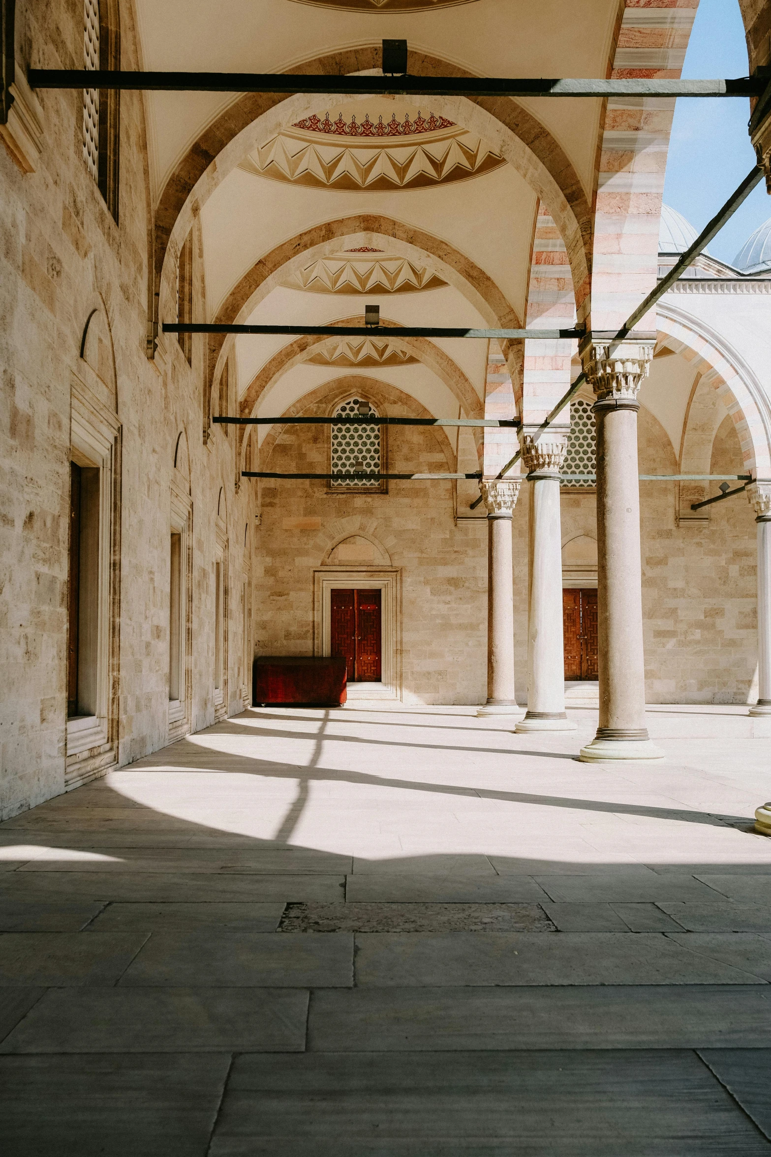 a large room with stone pillars and arches