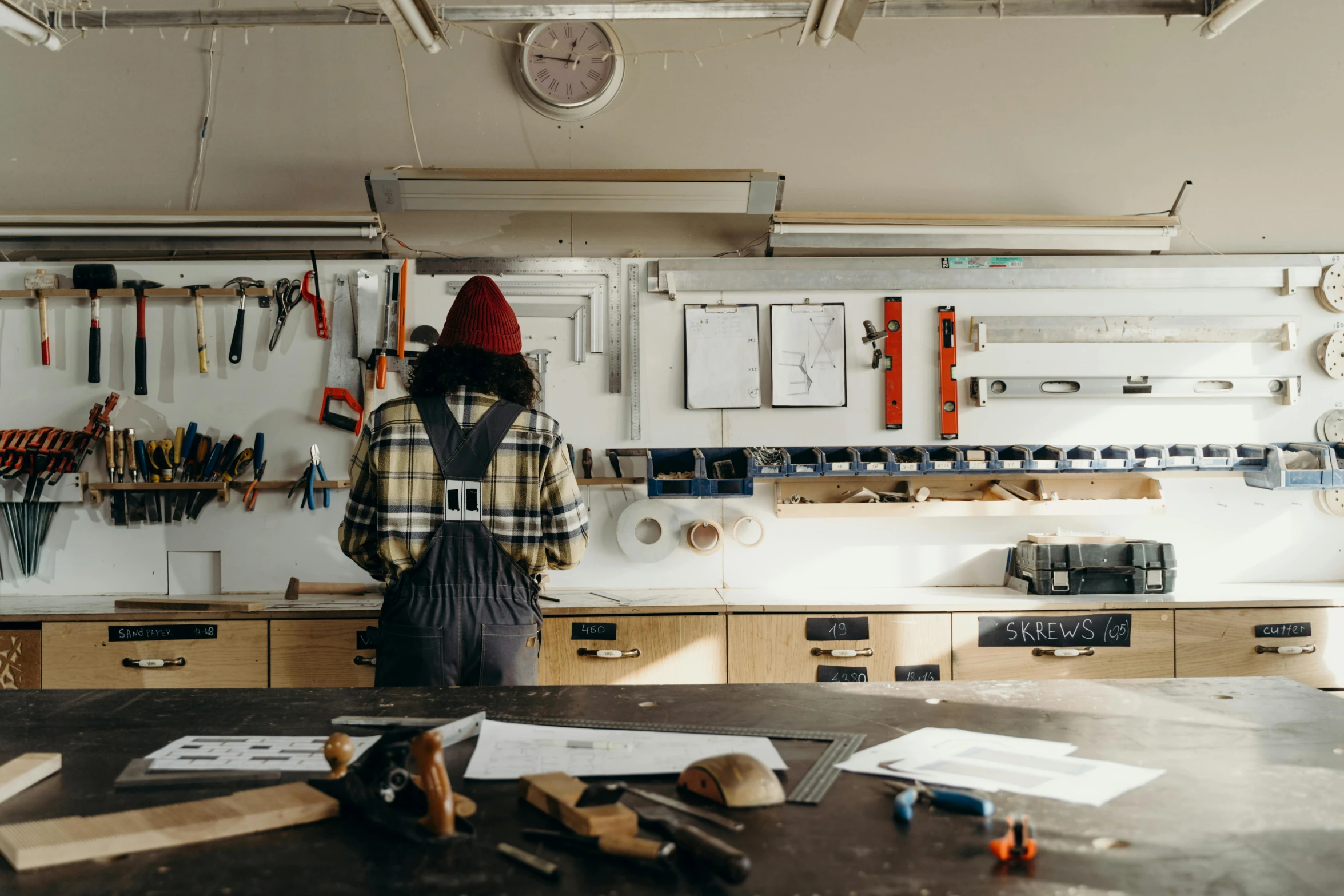 a person stands in a room with tools all over