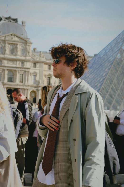 a man is wearing a blazer and tie