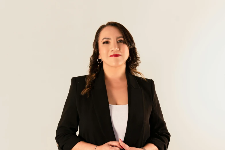 a woman posing for a po while wearing a black coat