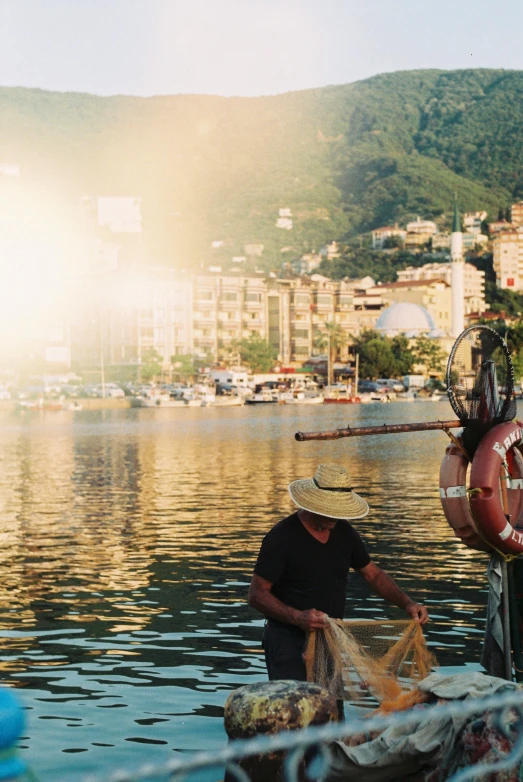 the man is cleaning up his stuff in the harbor