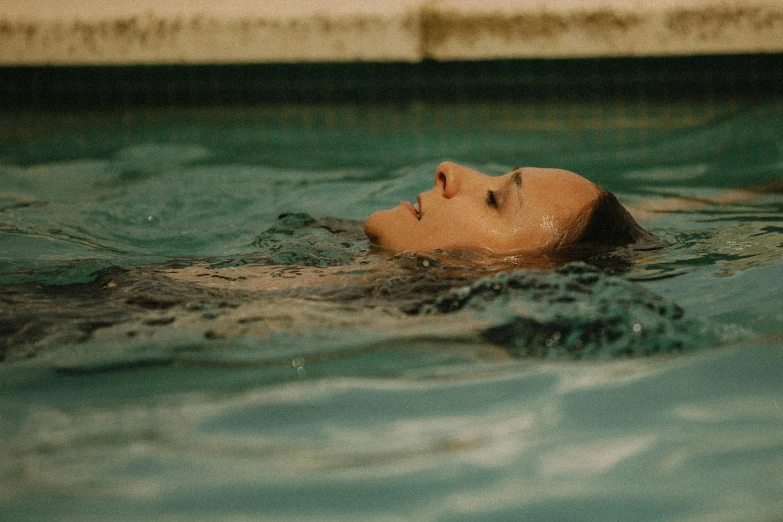 a woman swimming in the pool at a resort