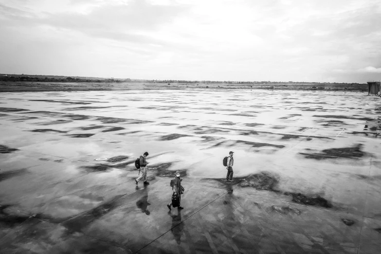 three people are walking through the water with snow