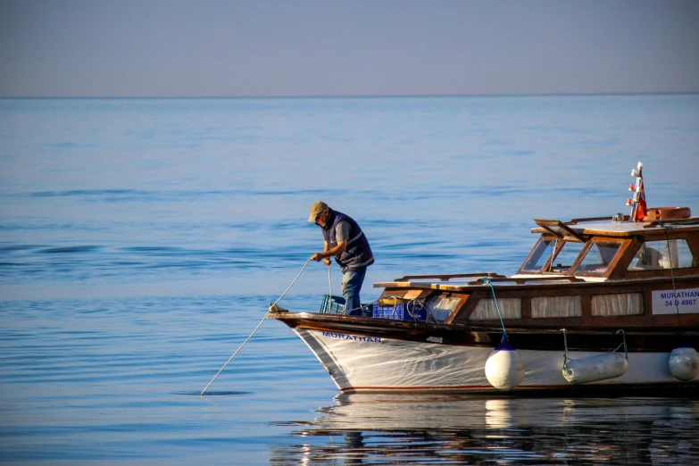 a man standing on top of a boat in the water