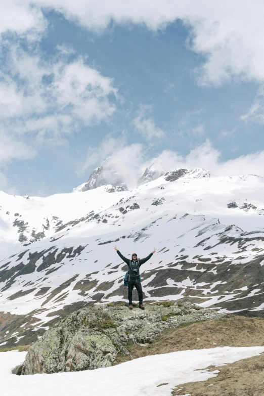 a man standing on top of a hill in the snow