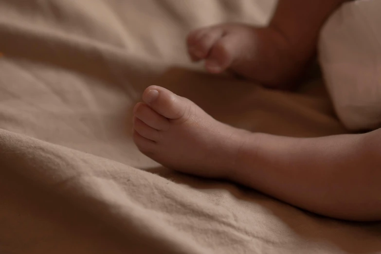 a picture of someone's foot with an unmade bed