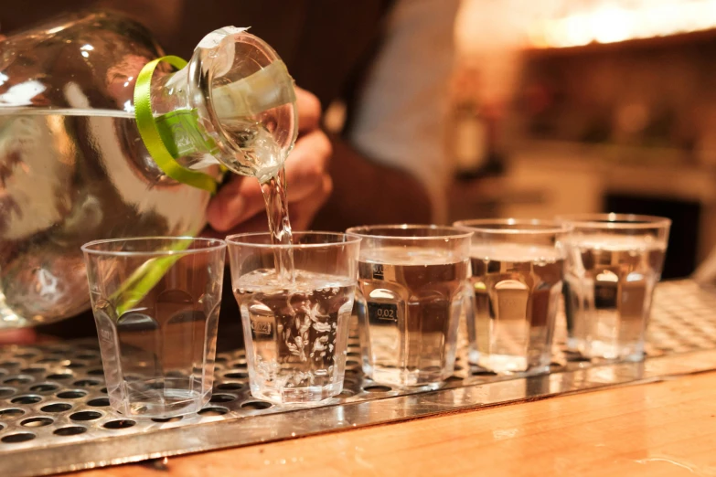 a person fills a s glass at a bar