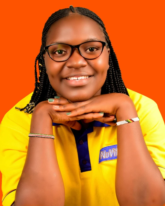 woman with large glasses sitting on orange background