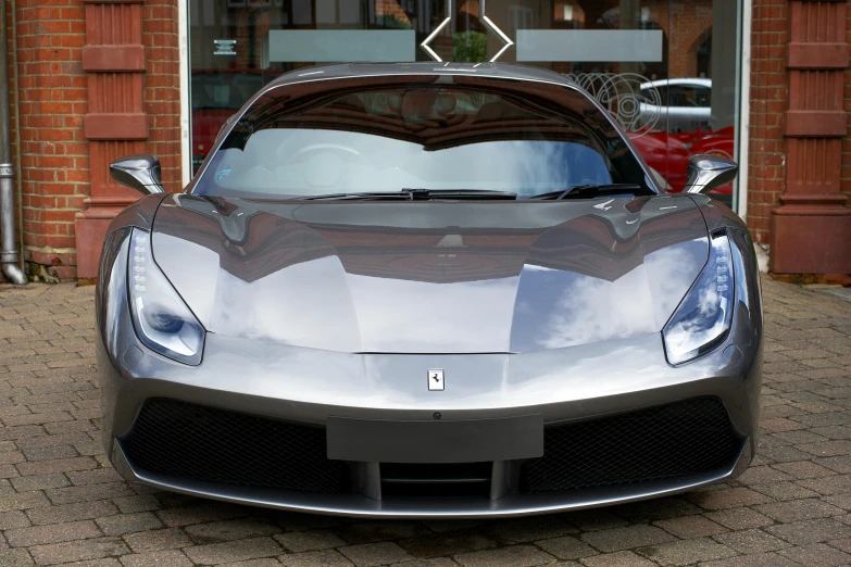 a ferrari on the ground outside a building