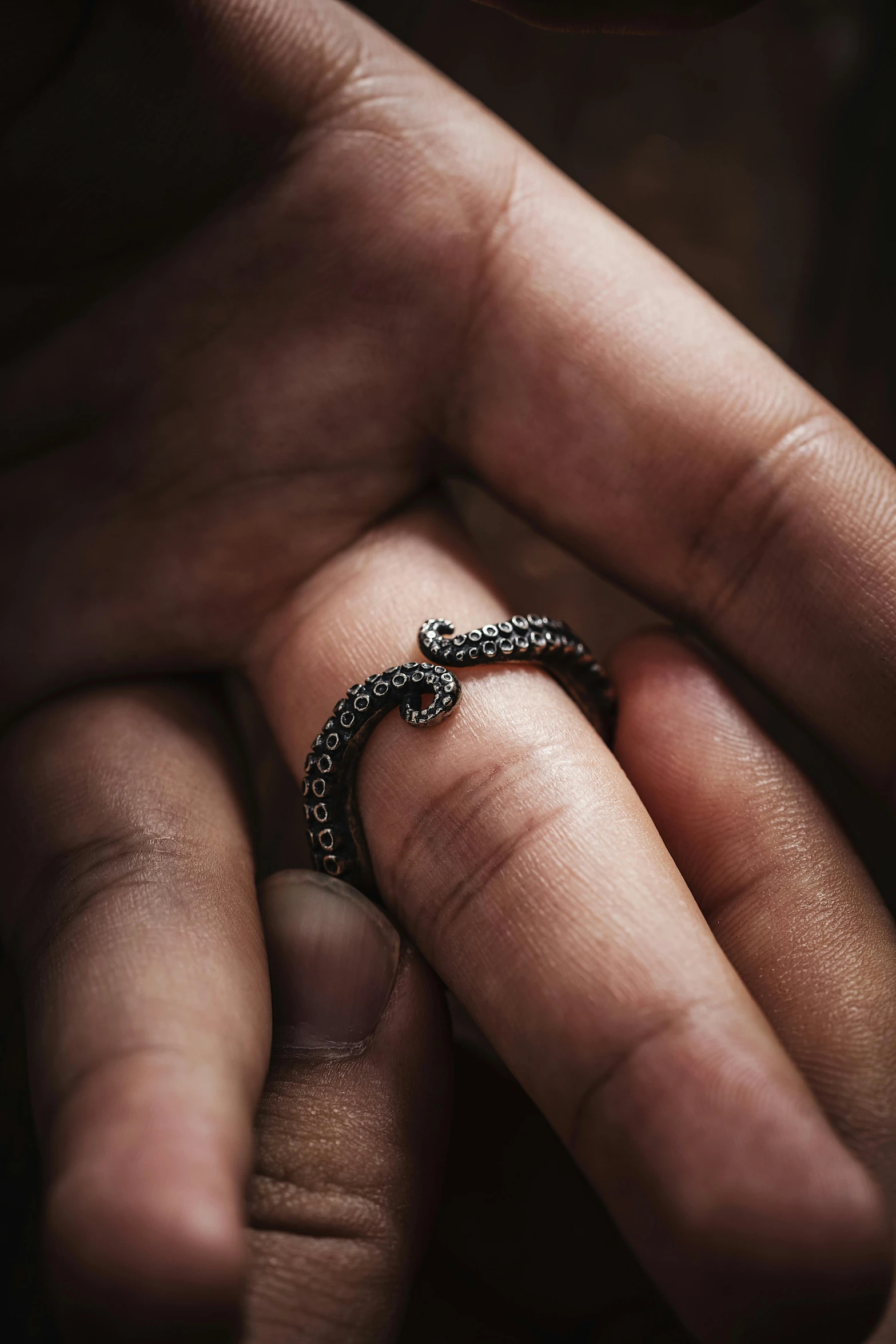 a person is holding onto a ring in the palm