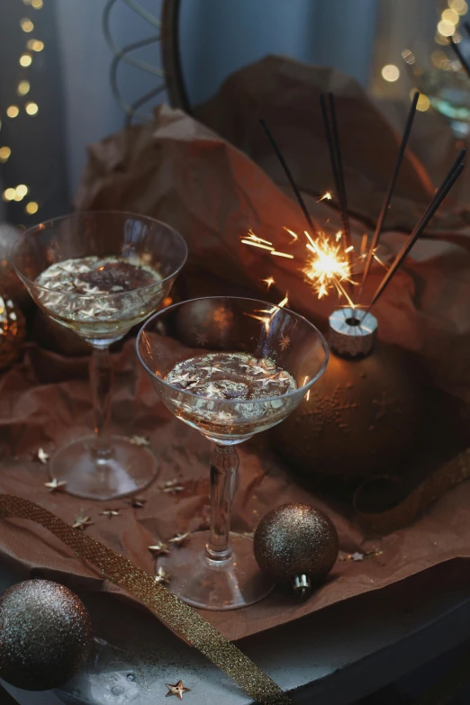 a glass filled with champagne, and some sparklers