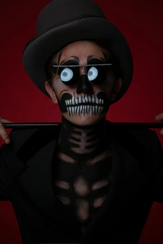 a skeleton with bright eyes and a top hat on