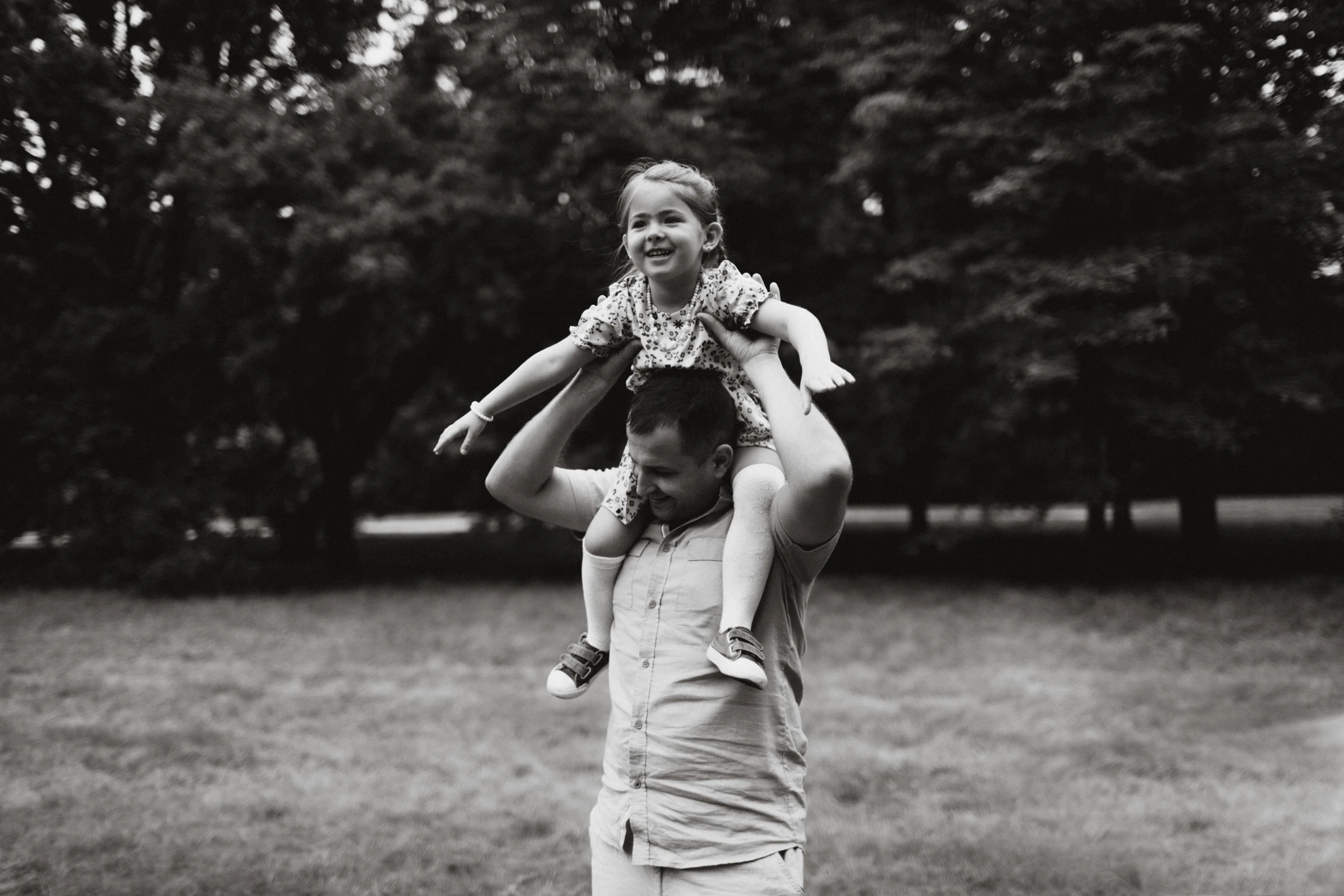 a man holding up a little girl in the air