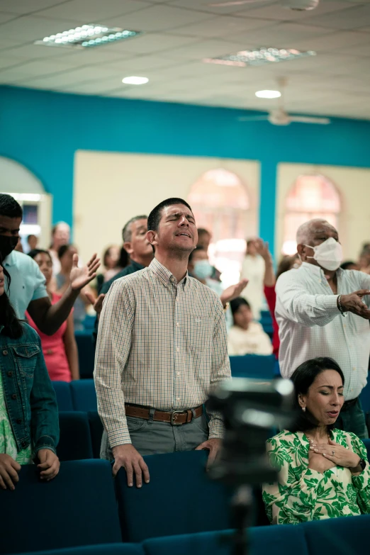 a man and woman standing in a room full of people