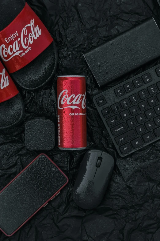 the coca - cola can is beside a keyboard and mouse