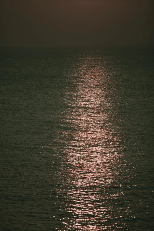 a lone boat floating alone on an empty sea