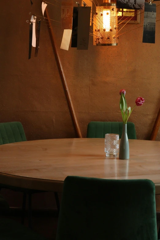 a wooden table sitting under two lights on a wall