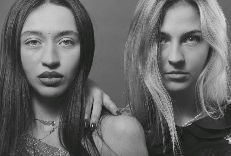 two women with very long hair looking up at the camera