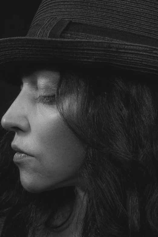 black and white pograph of a woman wearing a hat